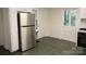 Eat-in Kitchen featuring stainless steel refrigerator and green linoleum floors at 35 E Catawba St, Belmont, NC 28012