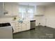 Well-lit kitchen featuring white cabinets and a stainless steel dishwasher at 35 E Catawba St, Belmont, NC 28012