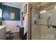 Updated bathroom featuring a glass-enclosed shower, wainscoting, and blue accent wall at 403 Garner Dr, Salisbury, NC 28146