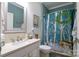 Charming bathroom featuring a sink vanity, a decorative shower curtain, and warm lighting at 403 Garner Dr, Salisbury, NC 28146
