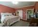 Spacious bedroom with hardwood floors, a large bed, and access to a bathroom with a sliding door at 403 Garner Dr, Salisbury, NC 28146