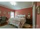 Cozy bedroom with warm color scheme, hardwood floors, and large window providing natural light at 403 Garner Dr, Salisbury, NC 28146