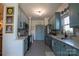 Spacious galley kitchen with white countertops, light blue cabinets, and stainless steel appliances at 403 Garner Dr, Salisbury, NC 28146