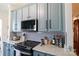 Modern kitchen with white countertops, light blue cabinetry, and a gray herringbone backsplash at 403 Garner Dr, Salisbury, NC 28146