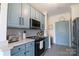 Updated kitchen features quartz countertops, stainless steel appliances, and light blue cabinetry at 403 Garner Dr, Salisbury, NC 28146