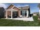 Backyard view highlighting a covered patio, perfect for outdoor seating, and access to a bright sunroom at 403 Garner Dr, Salisbury, NC 28146