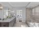 Bright bathroom features a large vanity, soaking tub and a glass shower enclosure at 4038 City Homes Pl, Charlotte, NC 28209