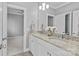 Bathroom featuring double sinks with granite countertops, white cabinetry, and decoratively adorned with fresh flowers at 4038 City Homes Pl, Charlotte, NC 28209