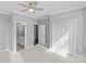 Bright bedroom with ceiling fan, neutral walls, plush carpet, and an ensuite bathroom at 4038 City Homes Pl, Charlotte, NC 28209