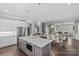 Open kitchen view with stainless steel appliances and island that flows into the living spaces at 4038 City Homes Pl, Charlotte, NC 28209