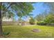 Beautiful backyard with a fire pit, green lawn, storage shed and mature trees providing shade and privacy at 4608 Mabry Pkwy, Rock Hill, SC 29732
