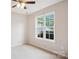 Bright bedroom featuring a ceiling fan, neutral carpet, and a large window with natural light at 4608 Mabry Pkwy, Rock Hill, SC 29732