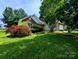 Exterior shot of home, showcasing the lawn, colorful landscaping, and attached two-car garage at 4608 Mabry Pkwy, Rock Hill, SC 29732