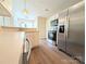 Bright kitchen boasts stainless steel refrigerator, microwave, oven, and wood floors at 4608 Mabry Pkwy, Rock Hill, SC 29732