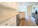 Well-lit kitchen featuring white cabinets, stainless steel appliances, and wood flooring at 4608 Mabry Pkwy, Rock Hill, SC 29732