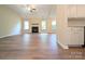 Spacious living room with hardwood floors, fireplace, lots of natural light, and modern ceiling fan at 4608 Mabry Pkwy, Rock Hill, SC 29732