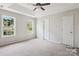 Spacious main bedroom with ceiling fan, neutral carpet, tray ceiling and large windows at 4608 Mabry Pkwy, Rock Hill, SC 29732