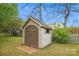 View of a storage shed with wooden doors and a brick foundation in a well-maintained backyard at 4608 Mabry Pkwy, Rock Hill, SC 29732