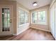 Cozy sunroom with many windows and natural light, featuring wood-look flooring at 4608 Mabry Pkwy, Rock Hill, SC 29732
