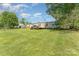 A nice lawn and white home exterior feature a lovely wooden deck at 4767 Stratford Ln, Denver, NC 28037