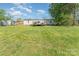 A well-maintained backyard and white home exterior features a nice wooden deck at 4767 Stratford Ln, Denver, NC 28037