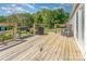 A spacious wooden deck with grilling area and rocking chair overlooks the backyard at 4767 Stratford Ln, Denver, NC 28037