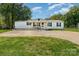 Charming home featuring a well-maintained front yard, white siding, and a cozy covered porch at 4767 Stratford Ln, Denver, NC 28037