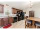 Functional kitchen featuring black appliances, wooden cabinetry, and an adjacent dining area at 4767 Stratford Ln, Denver, NC 28037
