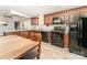 Functional kitchen featuring black appliances, wooden cabinetry, and an adjacent dining area at 4767 Stratford Ln, Denver, NC 28037