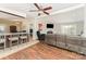 Open-concept living room featuring a fireplace, hardwood floors, and a seamless flow to the kitchen at 4767 Stratford Ln, Denver, NC 28037