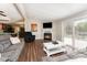 Cozy living room with a fireplace, access to the deck, and an open view of the kitchen at 4767 Stratford Ln, Denver, NC 28037