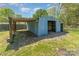 A blue outbuilding with covered storage in the home's backyard at 4767 Stratford Ln, Denver, NC 28037