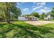 Home featuring a large concrete pad and well-manicured lawn, perfect for outdoor activities at 4767 Stratford Ln, Denver, NC 28037