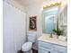 Compact bathroom featuring a shower tub combo and white vanity with a framed mirror at 5007 Sharon Rd # S, Charlotte, NC 28210