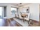 Dining area with a modern light fixture and a large window with natural light at 5007 Sharon Rd # S, Charlotte, NC 28210