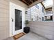 Condo entrance with a storm door, a welcome mat, and nice landscaping at 5007 Sharon Rd # S, Charlotte, NC 28210