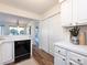 Kitchen with white cabinets, black dishwasher, and an open view to other rooms at 5007 Sharon Rd # S, Charlotte, NC 28210
