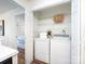 Convenient laundry closet with washer, dryer, and shelving for storage, accessible from kitchen at 5007 Sharon Rd # S, Charlotte, NC 28210