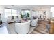 Open-concept living and dining area with hardwood floors and bright lighting at 5007 Sharon Rd # S, Charlotte, NC 28210