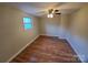 Cozy bedroom features neutral walls, a ceiling fan and new hardwood floors at 5628 Anderson Rd, Charlotte, NC 28269