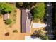 Aerial view of a home with a new roof, mature trees, a gravel driveway, and a private setting at 6057 Highway 97 Hwy, Hickory Grove, SC 29717