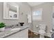 Well-lit bathroom features a granite countertop, toilet, and sink near a window at 6057 Highway 97 Hwy, Hickory Grove, SC 29717
