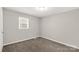 An empty bedroom offers neutral colors and carpeted floors, illuminated by natural light at 6057 Highway 97 Hwy, Hickory Grove, SC 29717