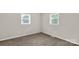 Cozy bedroom featuring neutral walls, two windows allowing natural light, and comfortable carpeting at 6057 Highway 97 Hwy, Hickory Grove, SC 29717