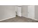 Neutral bedroom showcasing door access, painted walls, soft carpeting and abundant natural light at 6057 Highway 97 Hwy, Hickory Grove, SC 29717