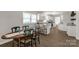 Open dining area with wooden table set for six adjacent to modern kitchen with granite countertops at 6057 Highway 97 Hwy, Hickory Grove, SC 29717