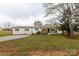 Ranch-style house features a painted brick exterior, metal roof, and welcoming front porch and long driveway at 6057 Highway 97 Hwy, Hickory Grove, SC 29717