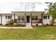 Charming home with a covered front porch, dark wood accents, and white painted brick at 6057 Highway 97 Hwy, Hickory Grove, SC 29717