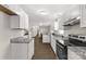 Bright, open kitchen design featuring modern appliances, granite countertops, and sleek white cabinetry at 6057 Highway 97 Hwy, Hickory Grove, SC 29717