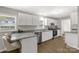 Modern kitchen features white cabinets, granite countertops, stainless steel appliances, and hardwood floors at 6057 Highway 97 Hwy, Hickory Grove, SC 29717